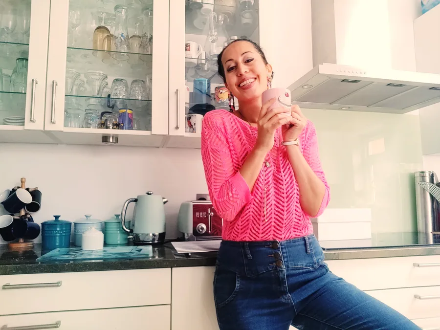 Tessa Brooks smiling in a kitchen, holding a mug